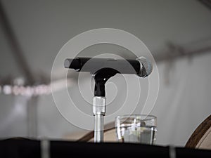 Microphone sitting on presenterÃ¢â¬â¢s table waiting for speaker